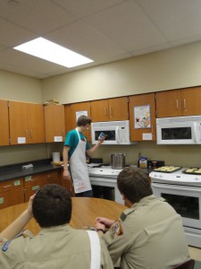 Commissary Chairman Jesse L. demonstrates a recipe at a training cell